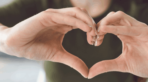 Woman-making-heart-hand-gesture